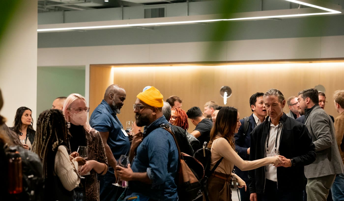 People mingling and talking at an indoor tech event in San Francisco
